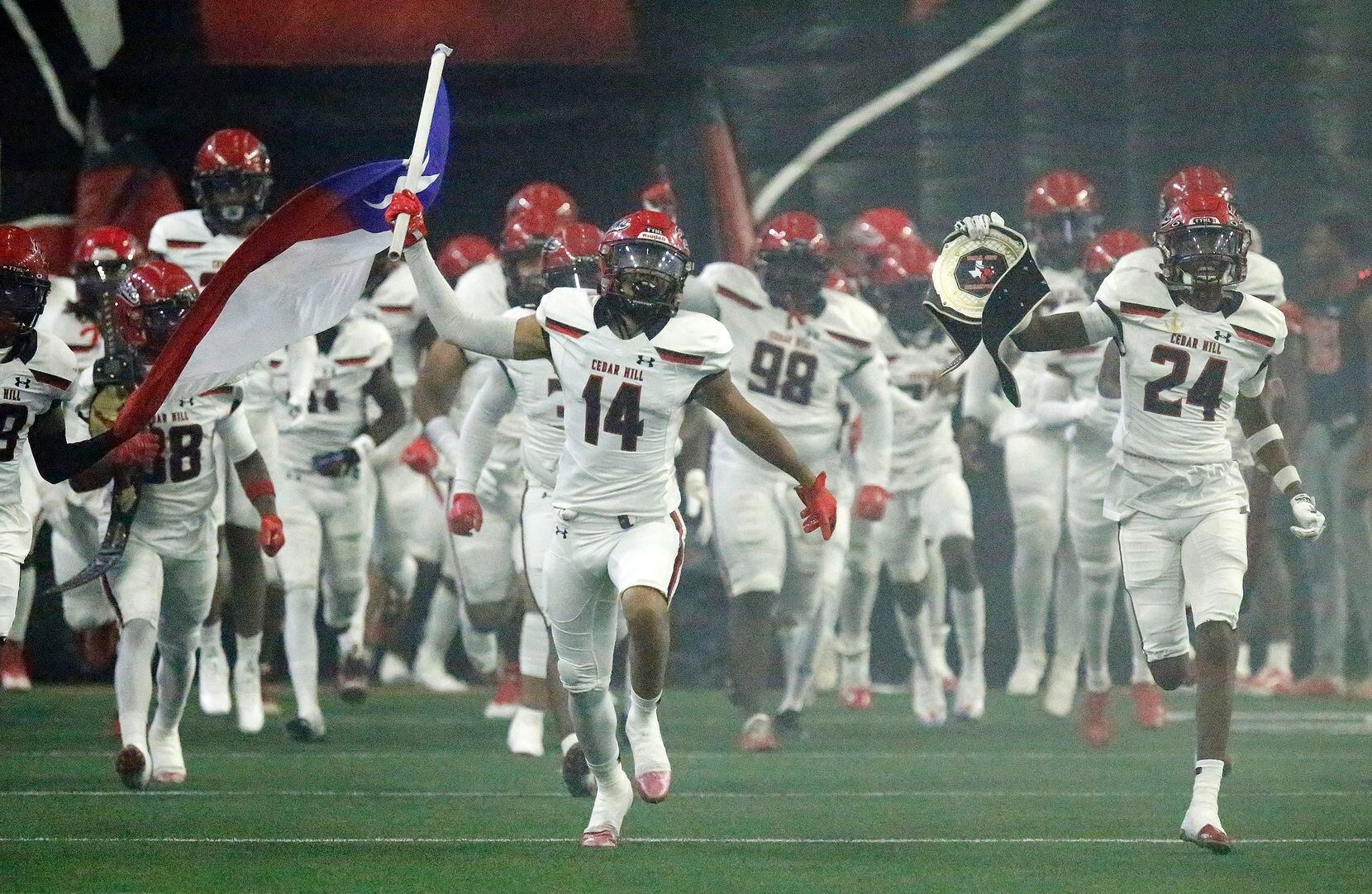 Cedar Hill wide receiver Derrick Wagoner (14) leads his team onto the field as part of the...