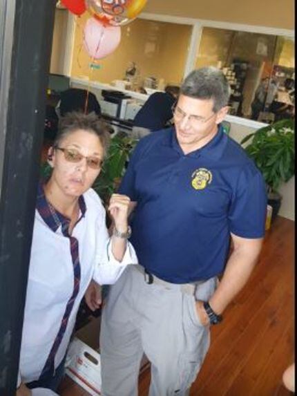 Tamara Mitchell argues with federal agents executing a search warrant at her pharmacy.