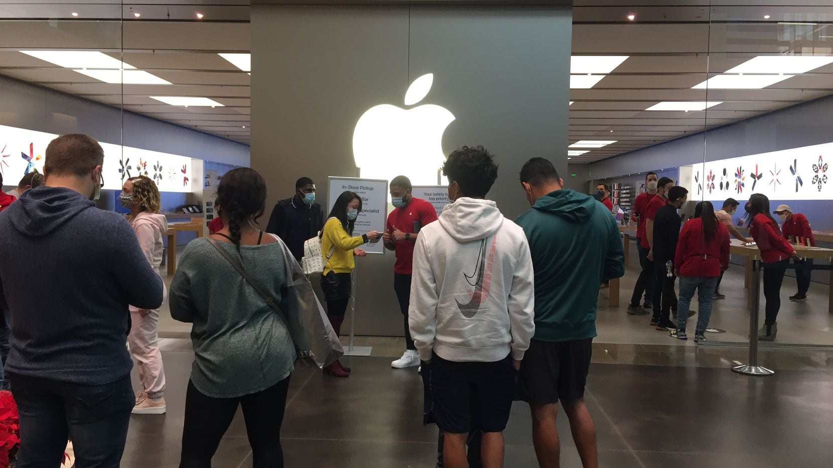 Shoppers wait in line to get into the NorthPark Center Apple store in Dallas on Black Friday.