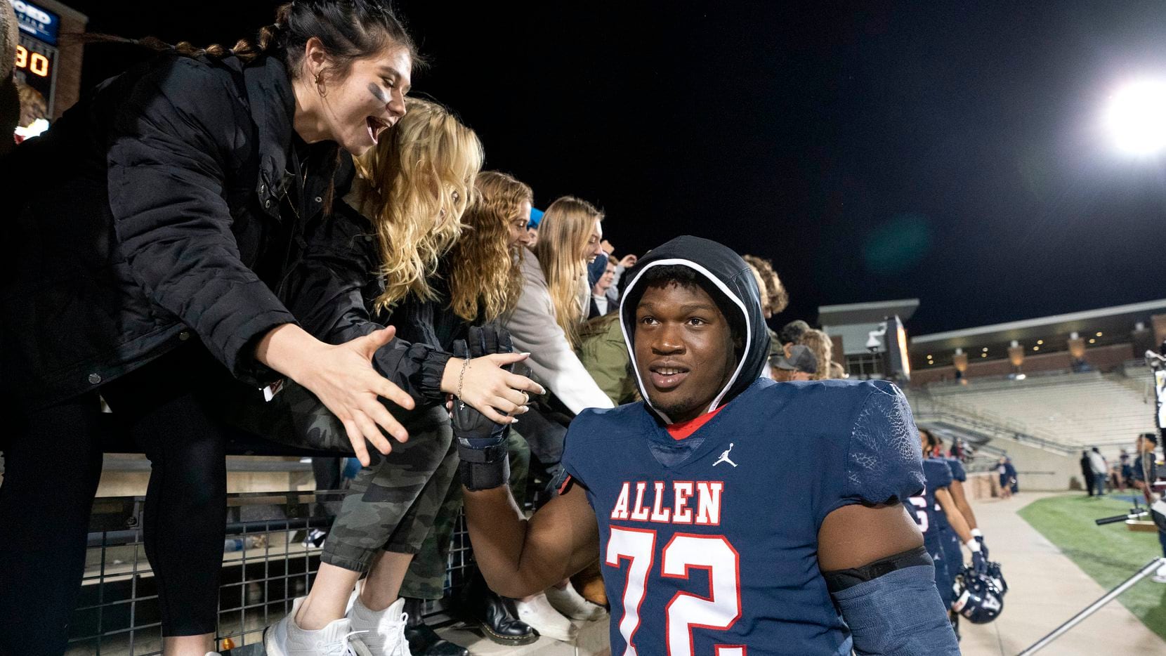 Allen senior offensive lineman Neto Umeozulu (72) celebrates with fans after his team’s 59-30 victory over Hebron in a bi-district round high school football playoff game on Friday, Nov. 12, 2021 at Eagle Stadium in Allen, Texas. (Jeffrey McWhorter/Special Contributor)