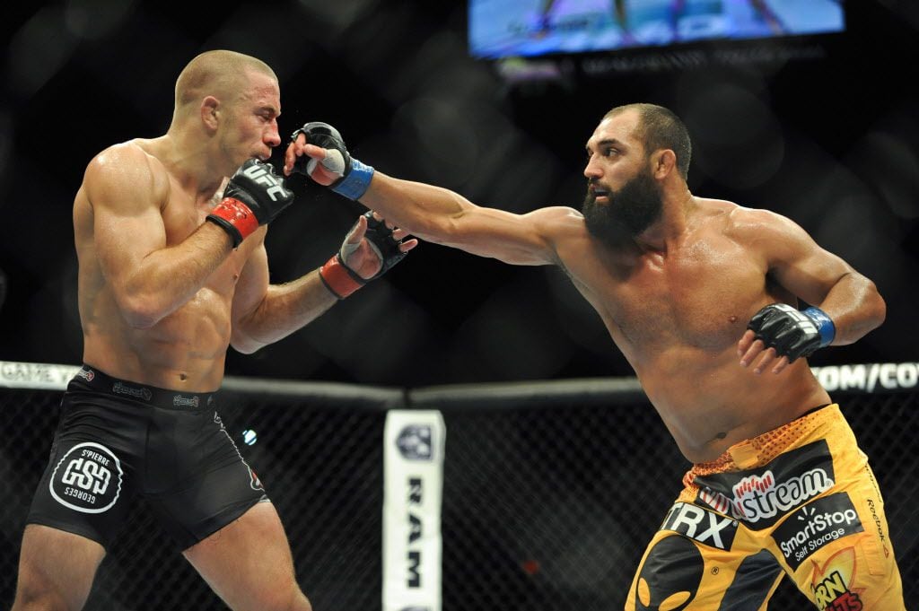 Nov 16, 2013; Las Vegas, NV, USA; Georges St-Pierre (red gloves) fights against Johny...
