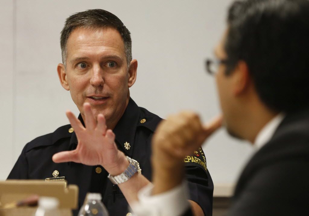 Robert Sherwin, who is now a Dallas police deputy chief, talks to Dallas county criminal court 10 judge Roberto Canas during a meeting about getting guns out of the hands of domestic abusers at the Family Place in Dallas, Texas on Friday, June 20, 2014. (Vernon Bryant/The Dallas Morning News)