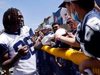 Dallas Cowboys wide receiver CeeDee Lamb (88) signs autographs for kids during the first...