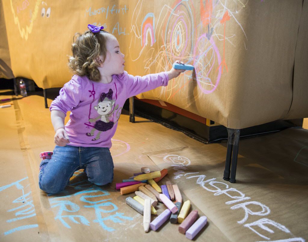 Zoe Brownlee, 1, draws with chalk inside the Women's Museum during The Dallas Festival of...