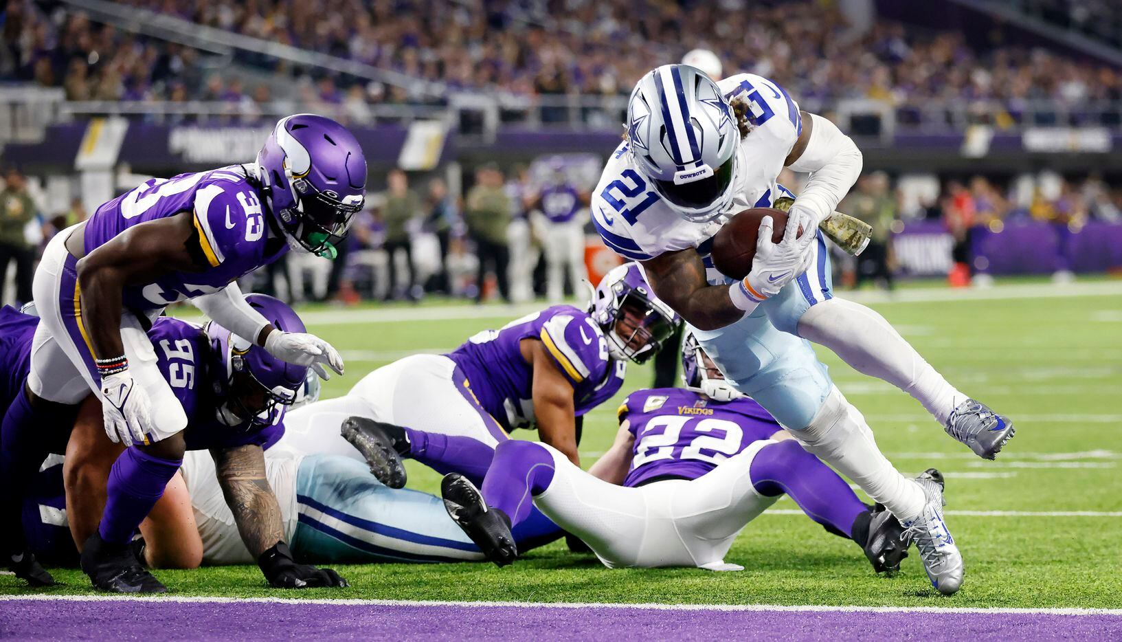 Dallas Cowboys running back Ezekiel Elliott (21) bounces off of Minnesota Vikings lineman...