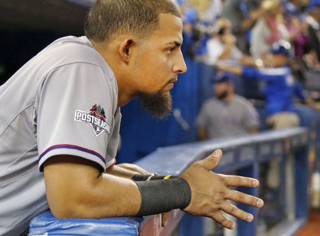 Texas Rangers second baseman Rougned Odor (12) watches the Blue Jays celebration the field...