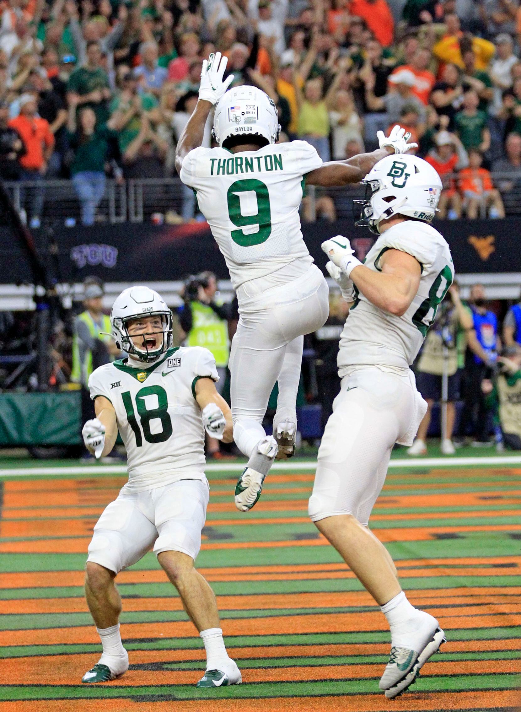 Baylor Bears wide receiver Tyquan Thornton (9) celebrates with teammates, including Baylor Bears wide receiver Drew Estrada (18), after catching a touchdown pass during first half of the Big 12 Championship football game against Oklahoma State at AT&T Stadium in Arlington on Saturday, December 4, 2021. (John F. Rhodes / Special Contributor)