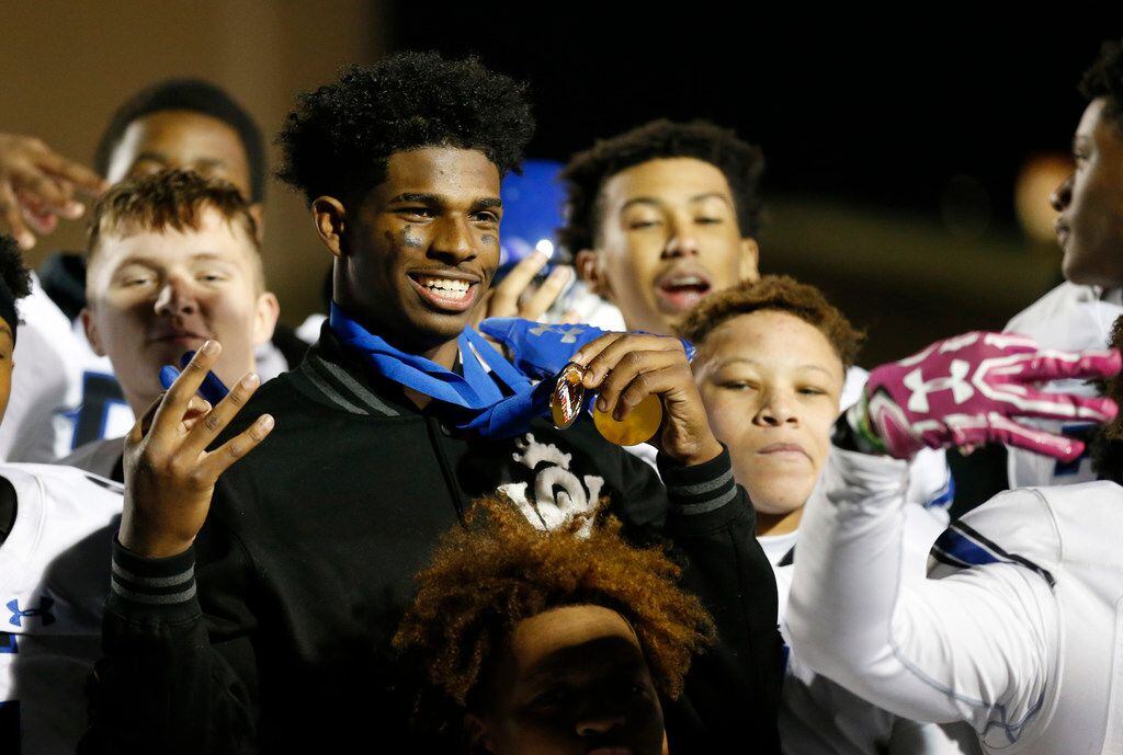 Trinity Christian's Shedeur Sanders (2) celebrates with teammates after they defeated Austin Regents 48-19 in the TAPPS Division II State Championship game at Waco Midway's Panther Stadium in Hewitt, Texas on Friday, December 6, 2019. Trinity Christian defeated Austin Regents 48-19. (Vernon Bryant/The Dallas Morning News)