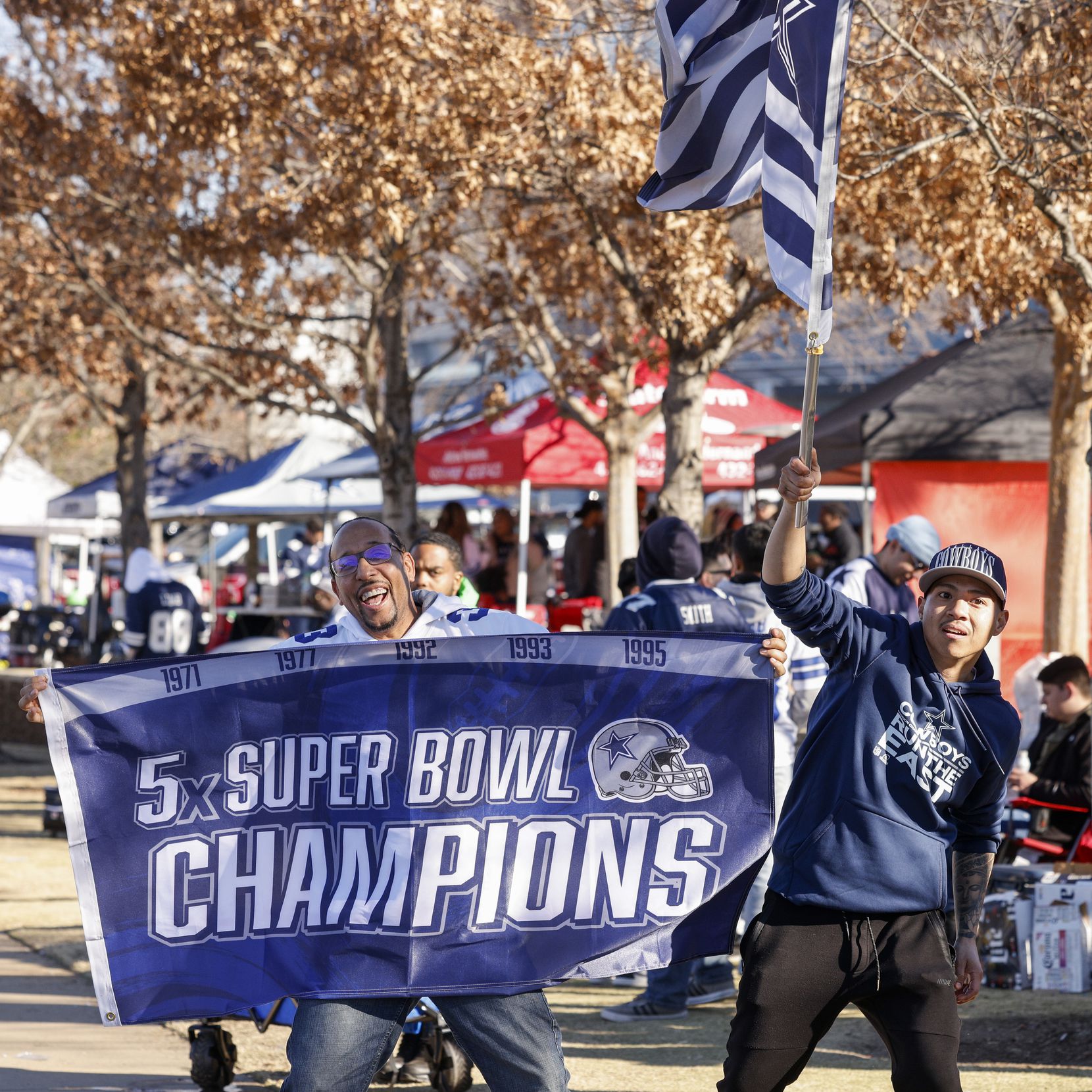 Khrys King (left) and Remy Sisavath wave Cowboys flags before an NFL wild-card playoff game...