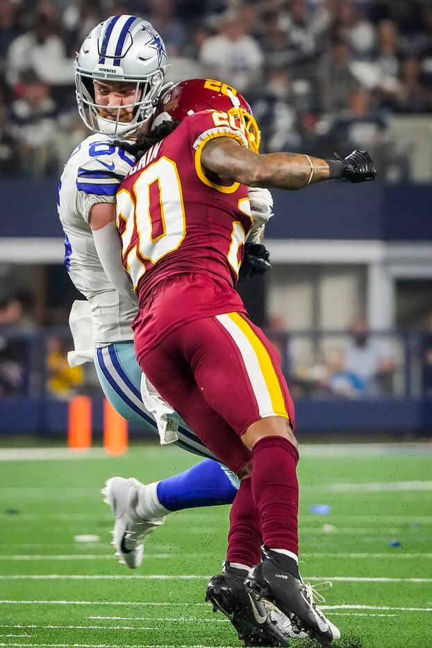 Dallas Cowboys tight end Dalton Schultz (86) is hit by Washington Football Team cornerback Bobby McCain (20) after catching a pass for a first down on a 4th down play during the first half of an NFL football game at AT&T Stadium on Sunday, Dec. 26, 2021, in Arlington.