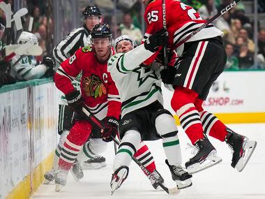 Dallas Stars center Ty Dellandrea (10) is knocked to the ice by Chicago Blackhawks...