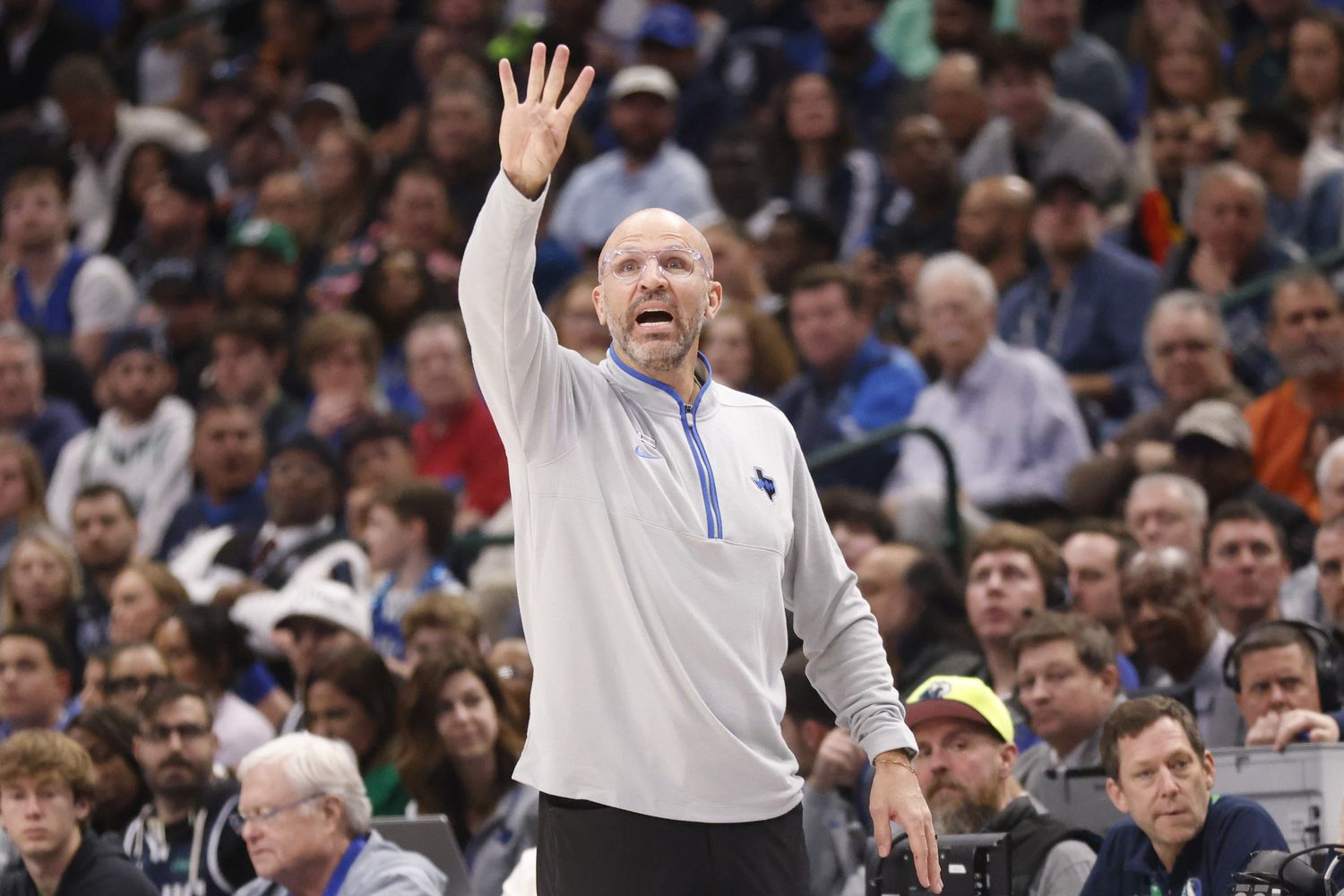 Dallas Mavericks head coach Jason Kidd signals to his players as the Milwaukee Bucks are...