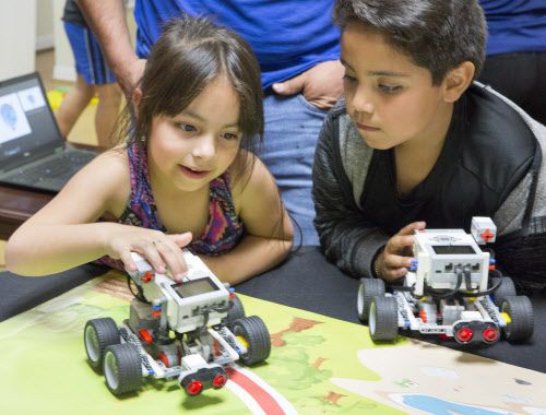 Abigail Vidaña, de 6 años y su hermano Haron, de 8, juegan con autos robóticos durante la...