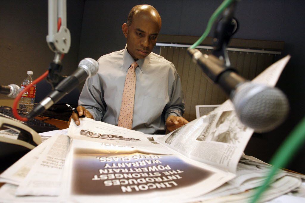 KKDA-AM (730) host Willis Johnson looks through a newspaper during a break on The Willis...