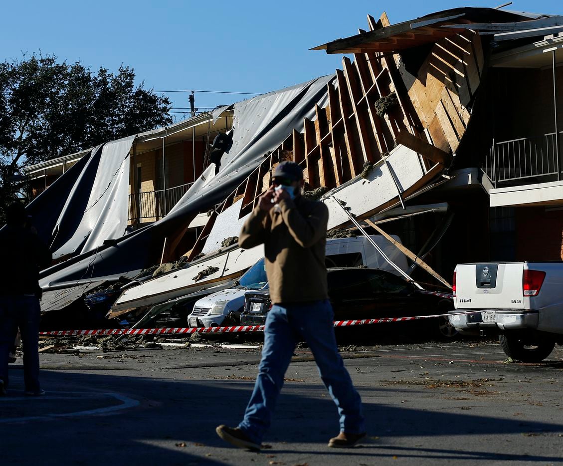 The roof of a Waterdance Apartments building was peeled off by a tornado-warned storm Tuesday night and landed on residents cars in the parking lot. Damage also occurred at The Mirage Apartments along Pioneer Parkway in Arlington, Wednesday, November 24, 2020.