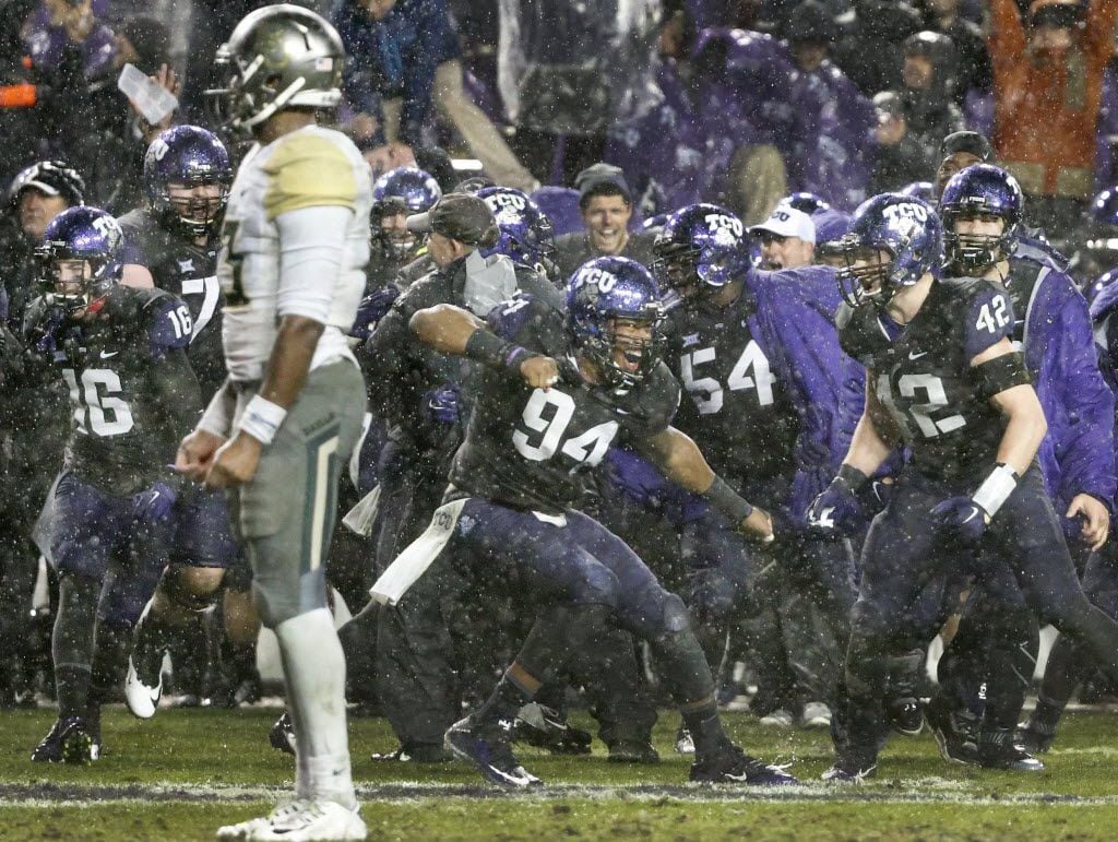 TCU Horned Frogs defensive end Josh Carraway (94) celebrates with teammates after the defense stopped Baylor Bears quarterback Chris Johnson (at left) and the Bears from getting a first down to end the game in overtime during the Baylor University Bears vs. the TCU Horned Frogs NCAA football game at Amon G. Carter Stadium in Fort Worth on Friday, November 27, 2015. (Louis DeLuca/The Dallas Morning News)
