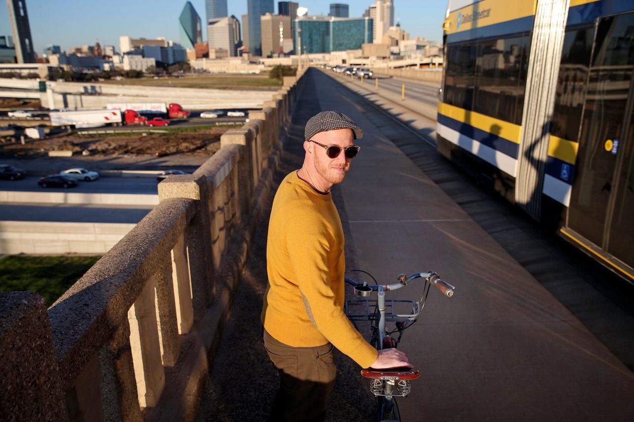 
Jason Roberts, co-founder of Bike Friendly Oak Cliff, says Dallas is slowly getting more bicycle-friendly, including adding some bike-dedicated lanes. Here he’s on the Houston Street viaduct  headed downtown as a Dallas streetcar passes by at rush hour.
