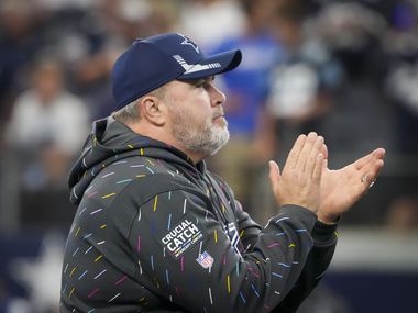 Dallas Cowboys head coach Mike McCarthy cheers his team as they warm up before an NFL football game against the Carolina Panthers at AT&T Stadium on Sunday, Oct. 3, 2021, in Arlington.