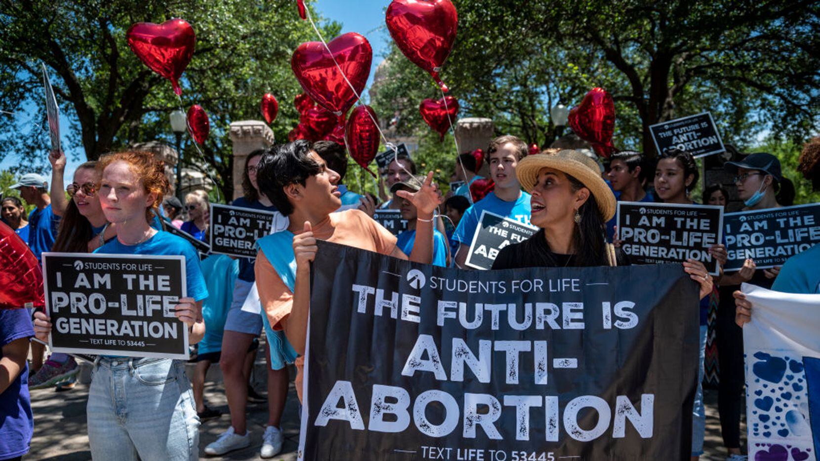 Pro-life protesters stand near the gate of the Texas Capitol on May 29, 2021.
