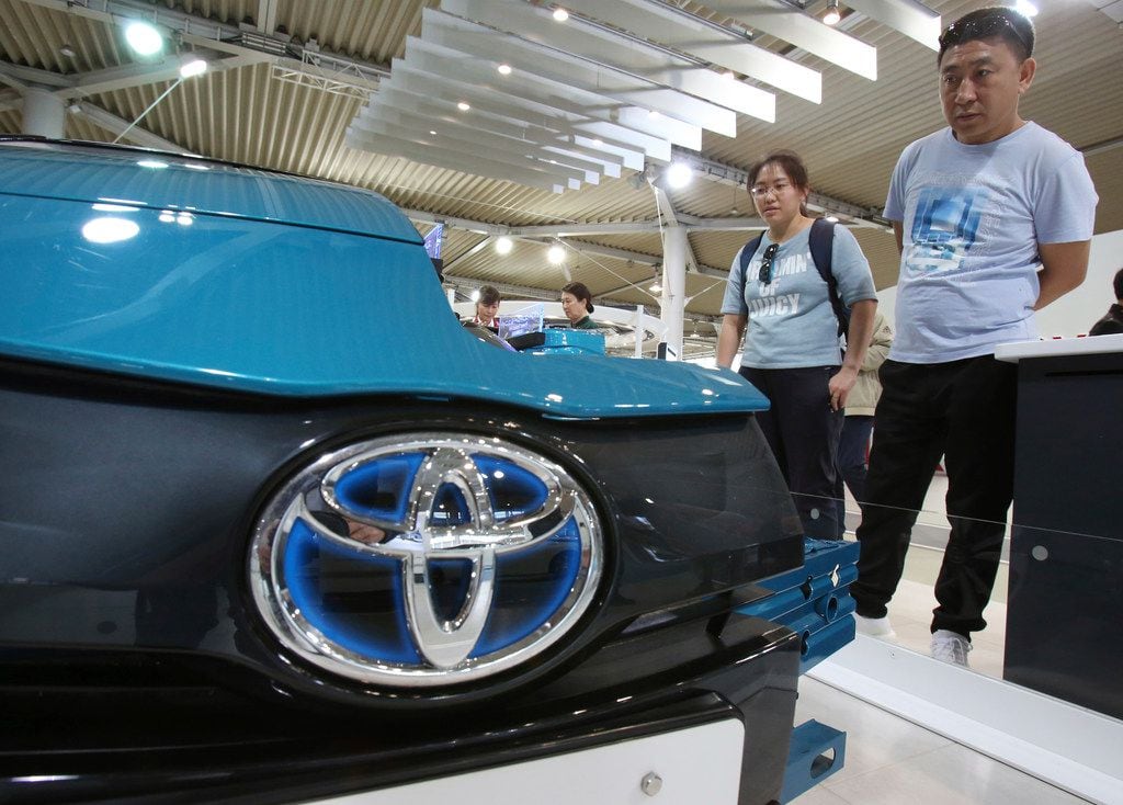 Visitors inspect Car at Toyota showroom in Tokyo, Wednesday, May 8, 2019. Japan's top...