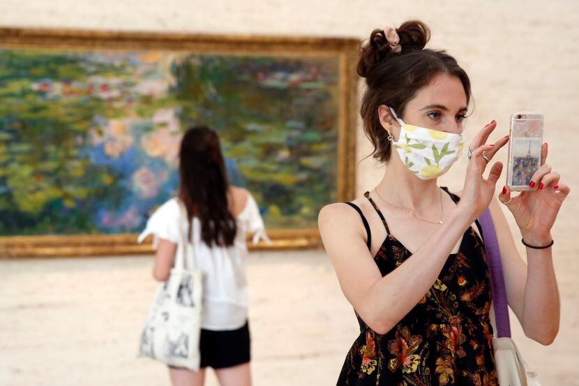 Libby Krueger of Fort Worth takes a photo of paintings in the Kimball Art Museum as her...