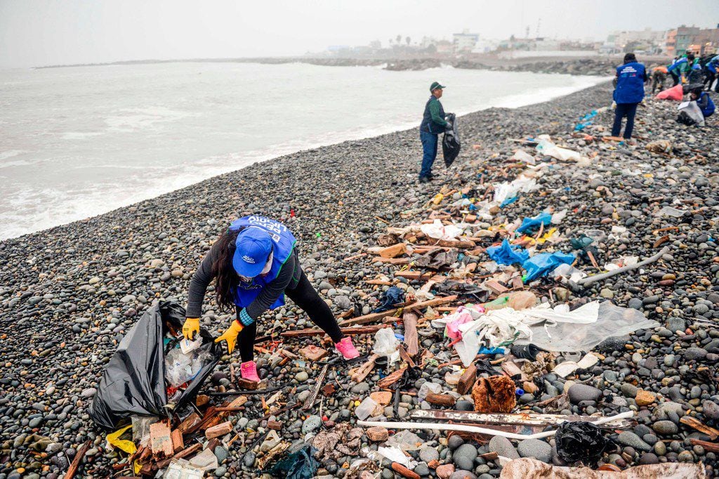 Volunteers clean up plastic waste on a beach in Lima, during the World Environment Day on...
