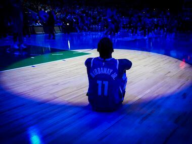 Dallas Mavericks forward Tim Hardaway Jr. watches pregame introductions before an NBA...