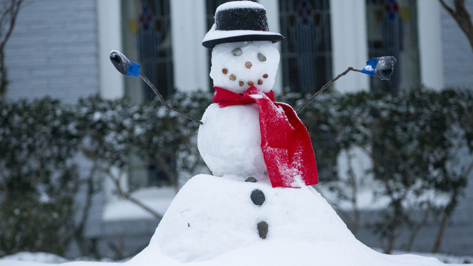 A snowman in Lower Greenville sits with fresh snow on its head in Dallas on Wednesday, Feb....