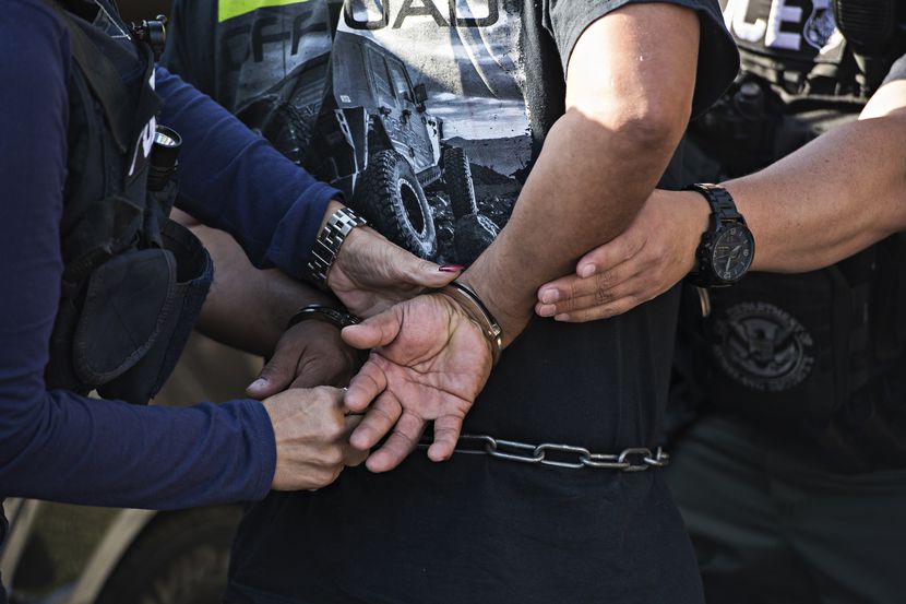 A man is arrested by Immigration and Customs Enforcement in Riverside, Calif., June 22,...