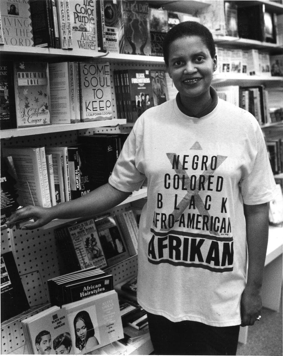 Emma Rodgers, owner of the former Black Images Book Bazaar, shows off a T-shirt for Black Names. The store closed in 2006.