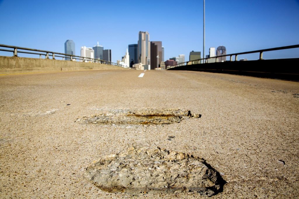 A pothole leading into downtown Dallas.