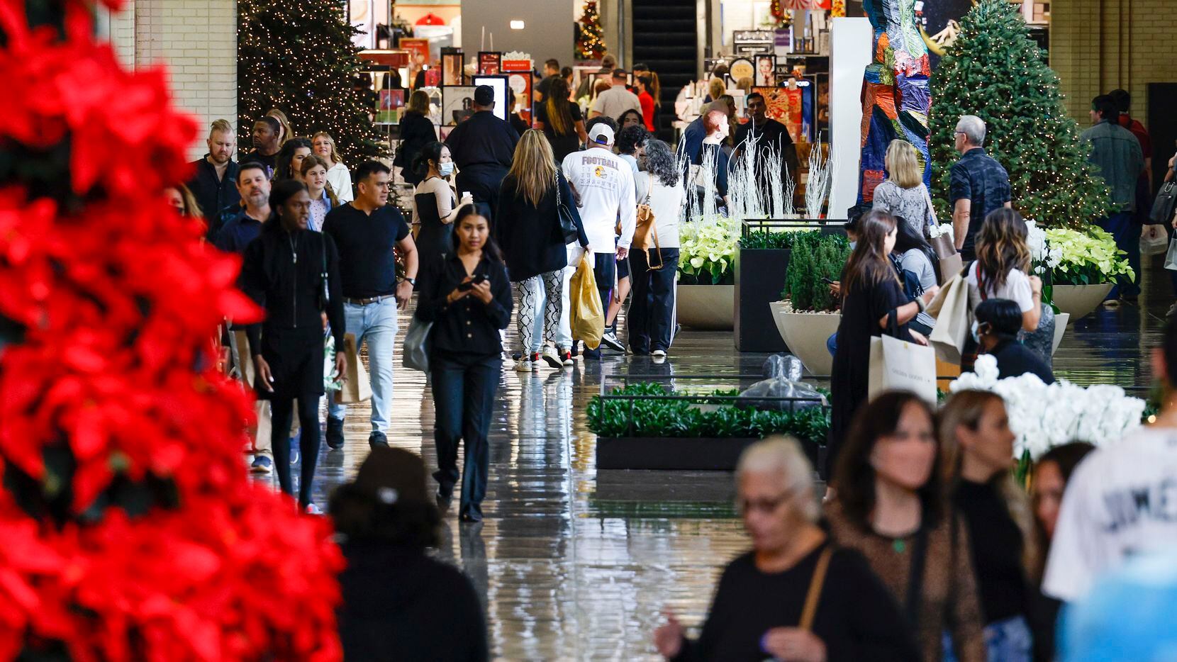 Shoppers walk at NorthPark Center in Dallas on Dec. 10.