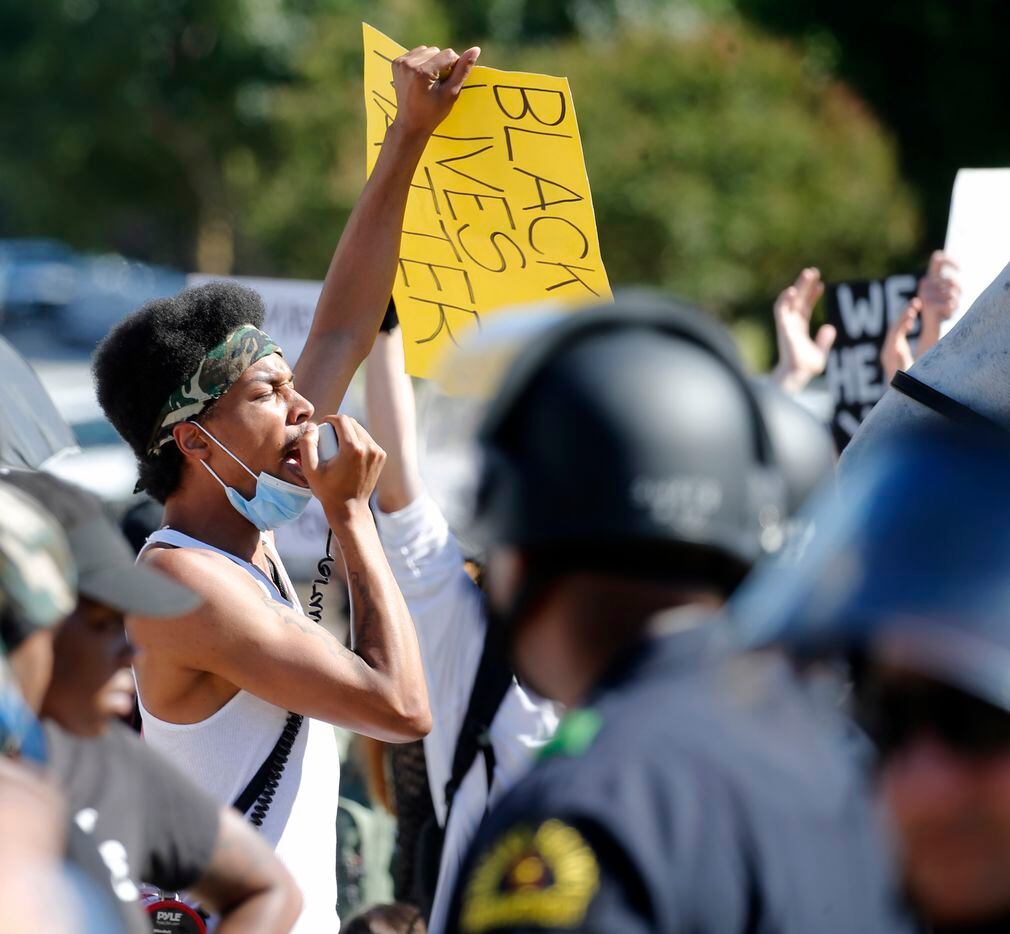 Dallas Police look on as protesters chant near Gateway Church Dallas Campus in Dallas on Thursday, June 11, 2020. President Donald Trump was in town for multiple events. (Vernon Bryant/The Dallas Morning News)