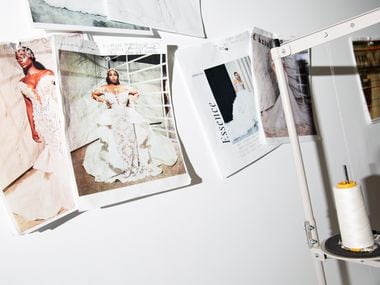 Wedding dress designs are posted on the wall at Esé Azénabor on Feb. 11. 