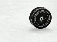 The puck rolls the length of the ice after an officials whistle during the Dallas Stars...