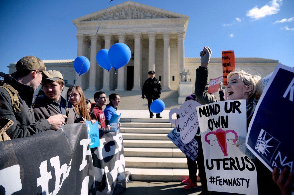 Supporters of legal access to abortion, as well as anti-abortion activists, rallied outside...