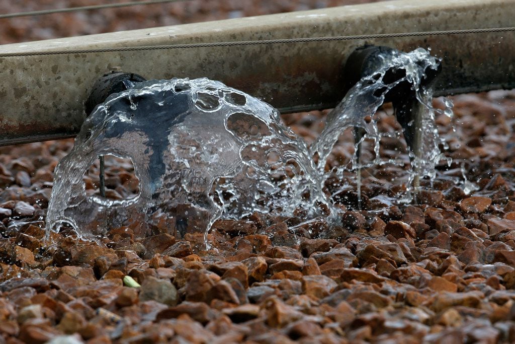 Water is pumped onto rocks of trickling filter that are used as a part of the wastewater...