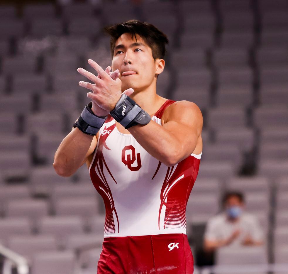 University of Oklahoma's Genki Suzuki claps after competing the pommel horse during Day 1 of...