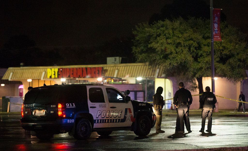 Arlington Police Department officers at the location of an officer-involved shooting at the...