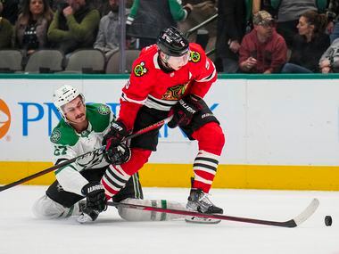 Dallas Stars left wing Mason Marchment (27) fights for the puck against Chicago Blackhawks...