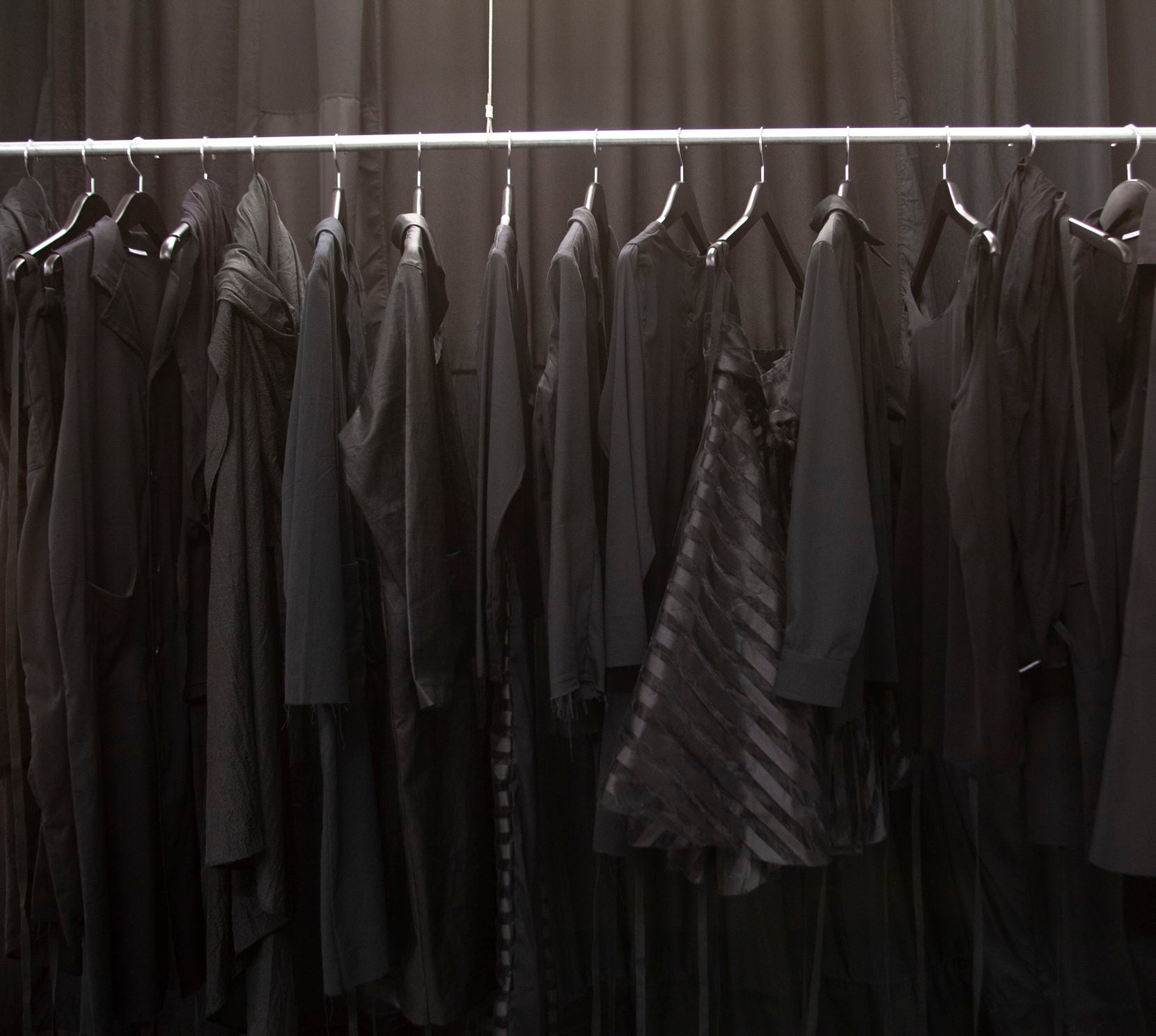 A clothing rack of black garments illustrates artist Joël Andrianomearisoa’s preferred color...