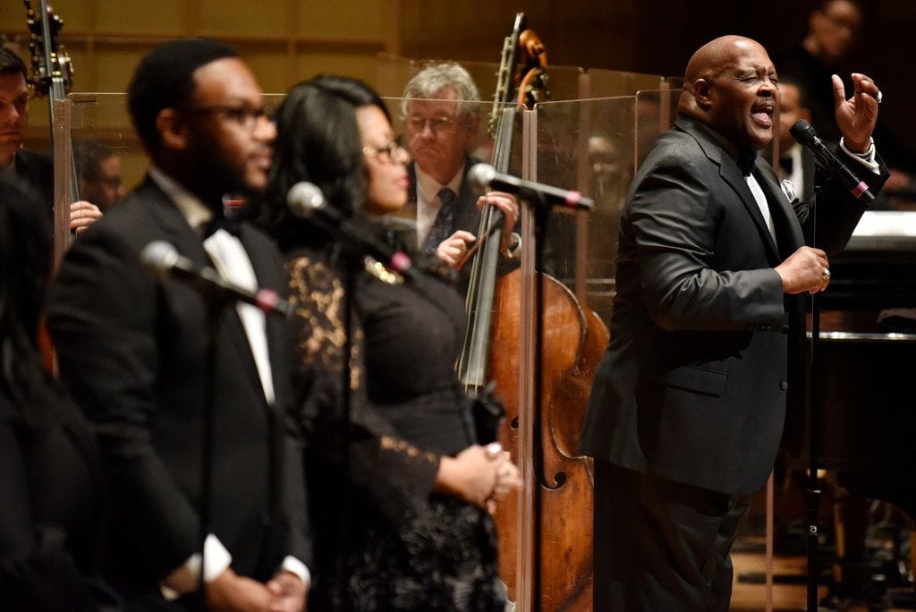 Marvin Winans, far-right, sings with the Dallas Symphony Orchestra during a performance of...
