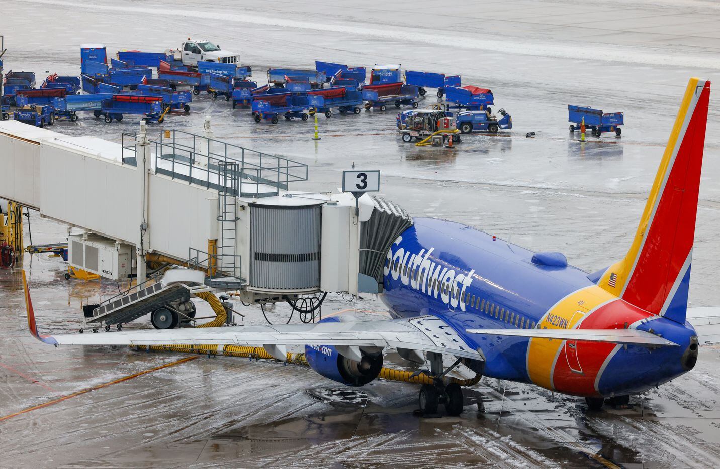 A plane with Southwest Airlines sits at one of the terminals at Dallas Love Field Airport in...