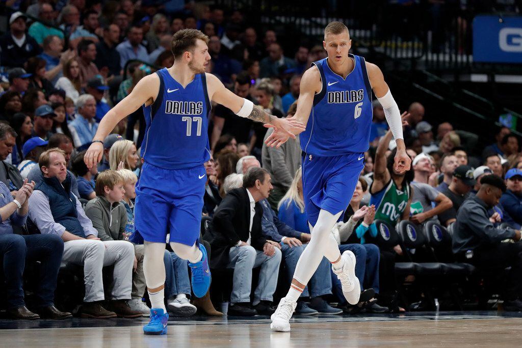 FILE - Mavericks guard Luka Doncic (77) and forward Kristaps Porzingis (6) celebrate a basket by Porzingis in the second half of a game against the Portland Trail Blazers in Dallas on Sunday, Oct. 27, 2019.