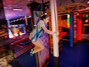 Ainsley Alexander, 11, of Grapevine is a blur as she rides the Sky Rider track around the...