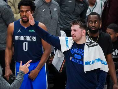 Dallas Mavericks guard Luka Doncic celebrates on the bench during the fourth quarter in Game...
