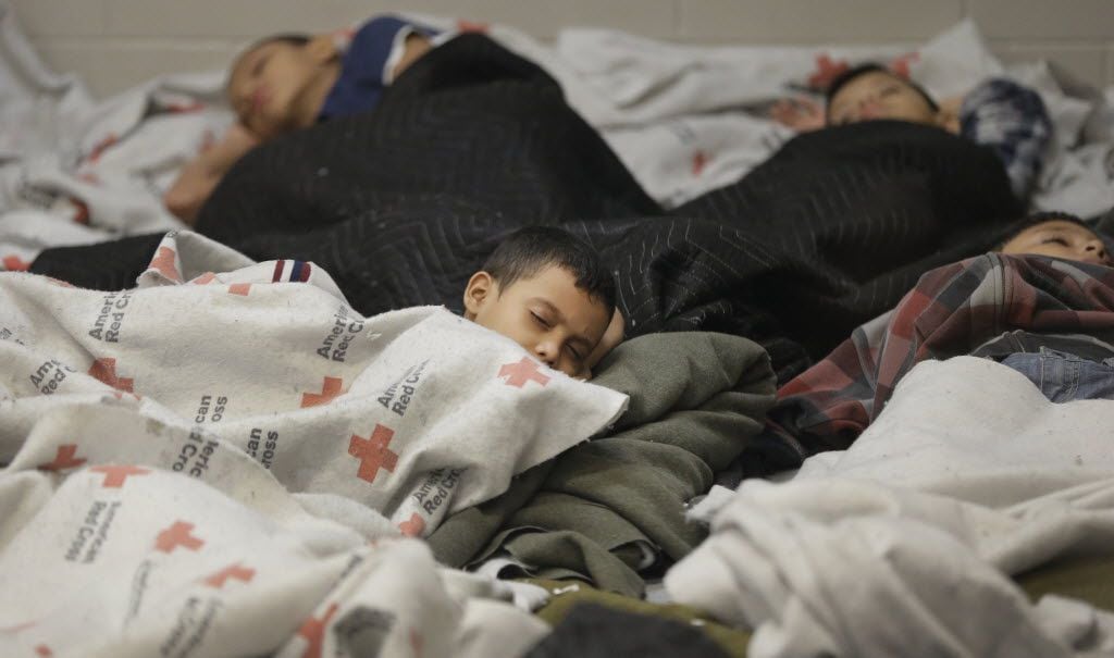 Migrant children slept in a holding cell at a U.S. Customs and Border Protection processing...