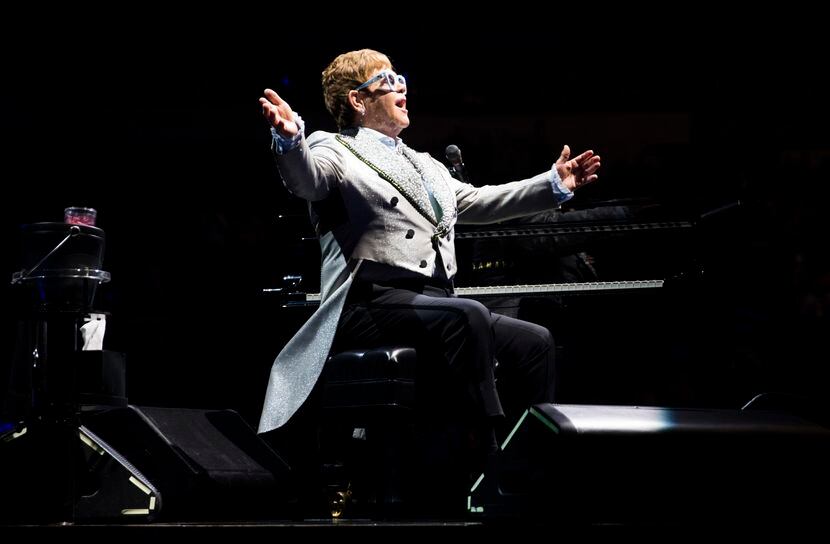 Elton John performs "Tiny Dancer" at American Airlines Center in Dallas on Friday, Dec. 14,...
