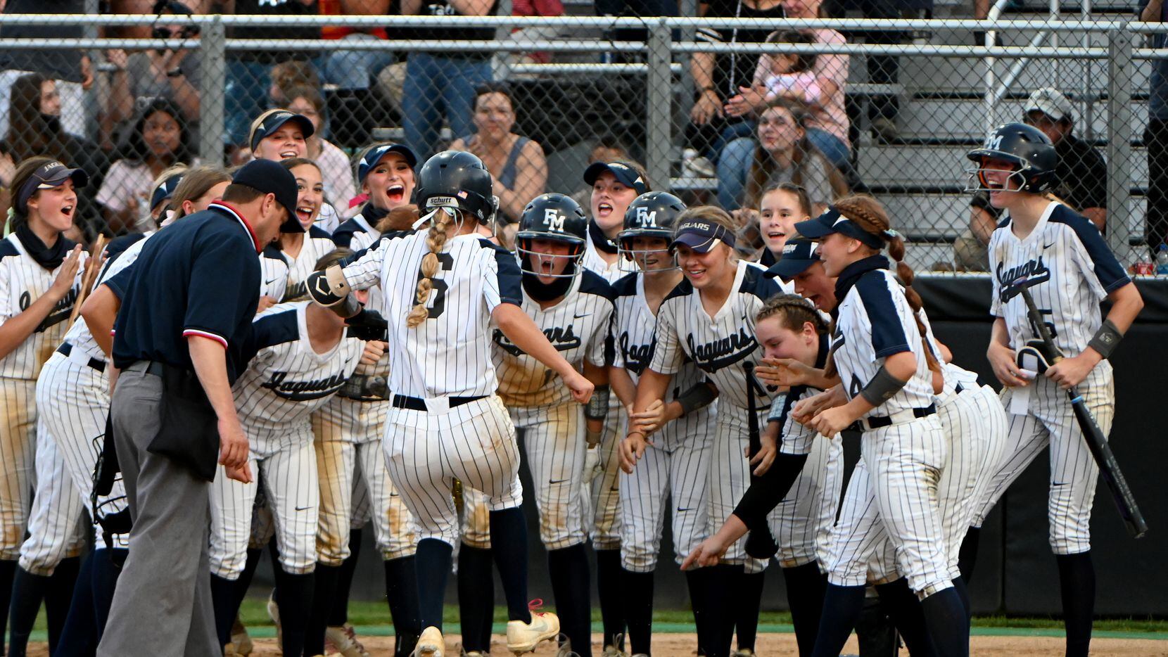 Flower Mound players wait at home plate to celebrate with McKenna Andrews (8) after her...