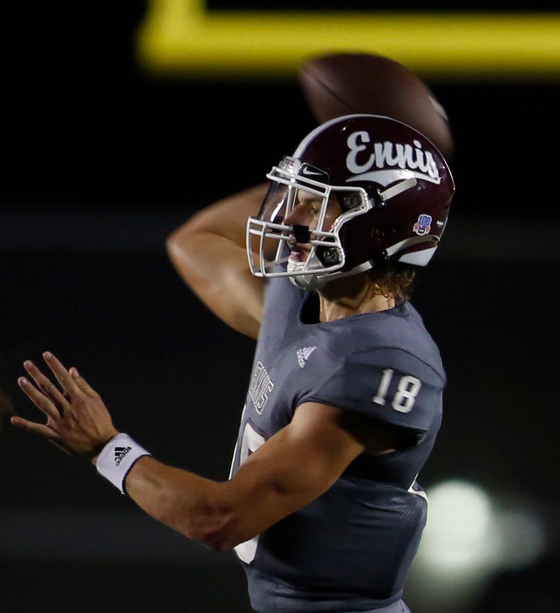 Ennis quarterback Collin Drake (18) directs a swing pass in the Lions backfield during...